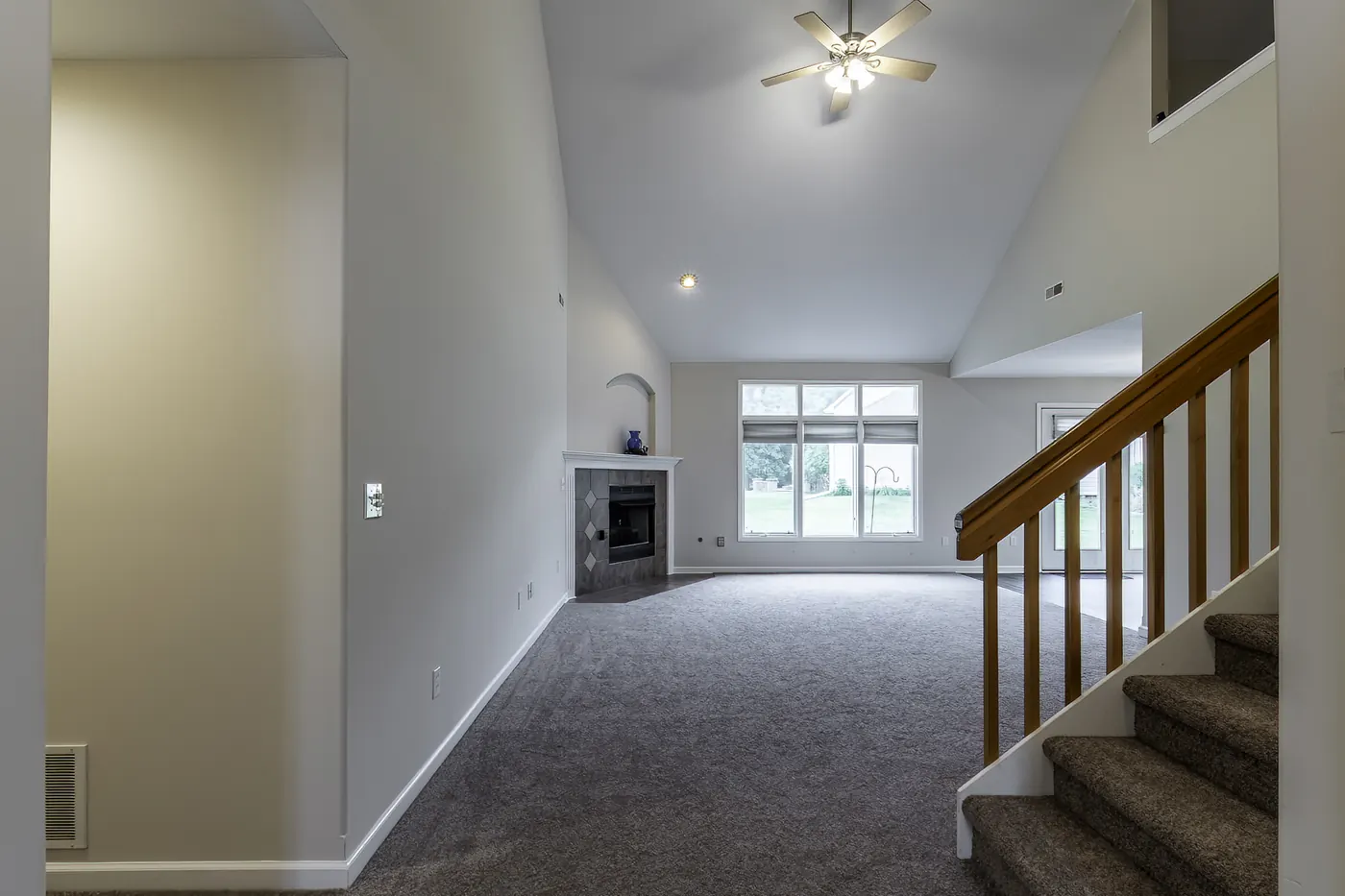 Vaulted great room with gas fireplace and large windows