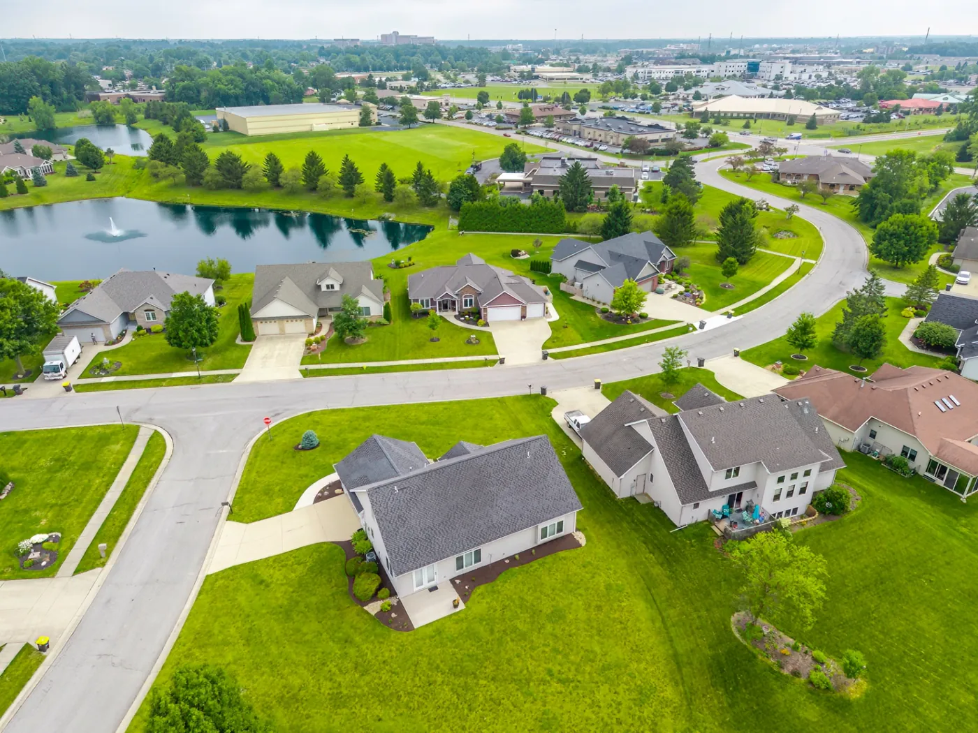 Aerial view of the home with the community pond